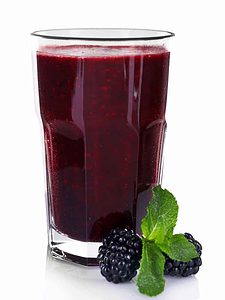 Glass of fresh blackberry cocktail 
