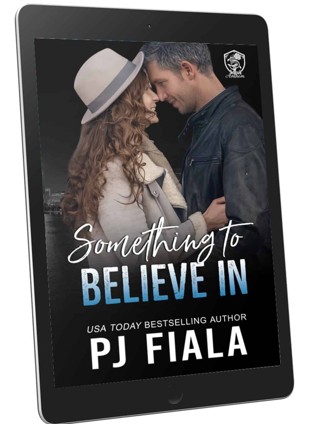 eBook cover of Something to Believe In by PJ Fiala displayed on a black tablet. The cover features a curly-haired woman in a light-colored hat and coat standing forehead to forehead with a silver-haired man in a leather jacket against a nighttime city skyline. Part of the Blossom Springs: Rogue Anthem series.