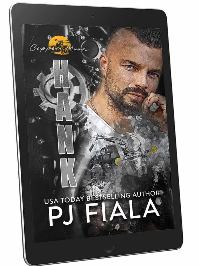 “iPad displaying the cover of Hank by USA Today bestselling author PJ Fiala. The cover features a rugged, blue-eyed man with a trimmed beard against a mechanical, gear-themed background with a vintage motorcycle overlay. The Copper Moon series logo sits at the top. A coastal romantic suspense vibe with strong racing elements.”